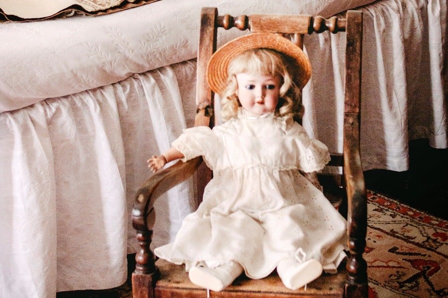 A doll sitting in a chair